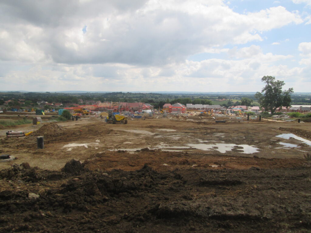 Bare earth and machinery on a large housing estate construction site
