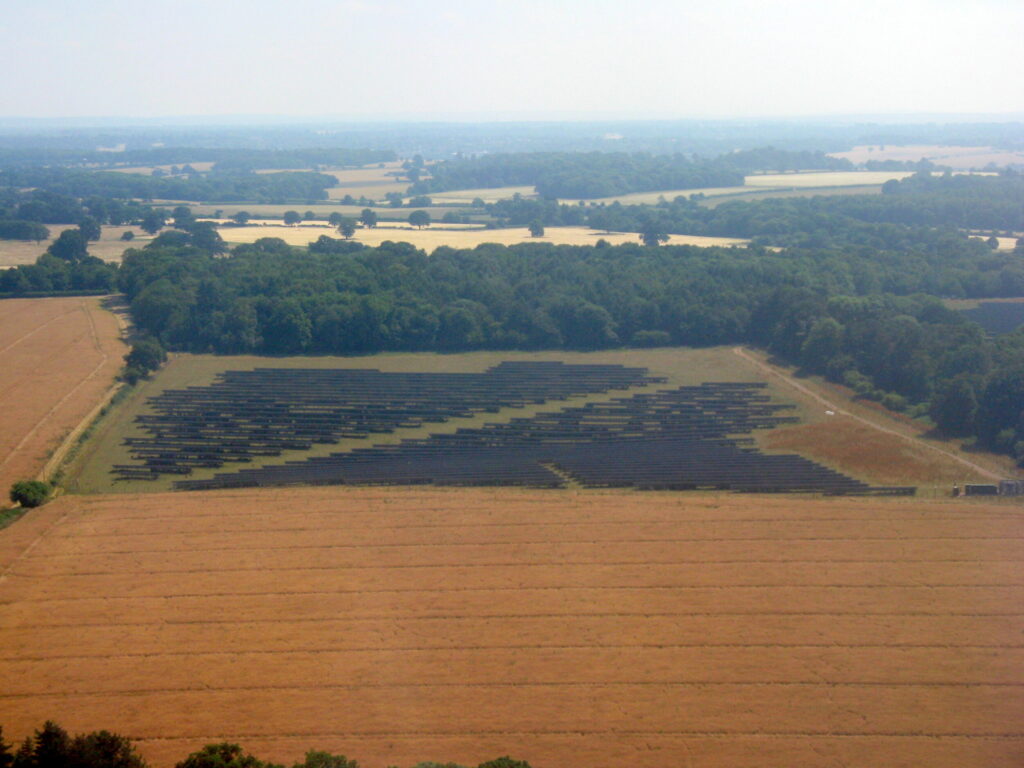 Aerial view of a solar farm covering fields in open countryside